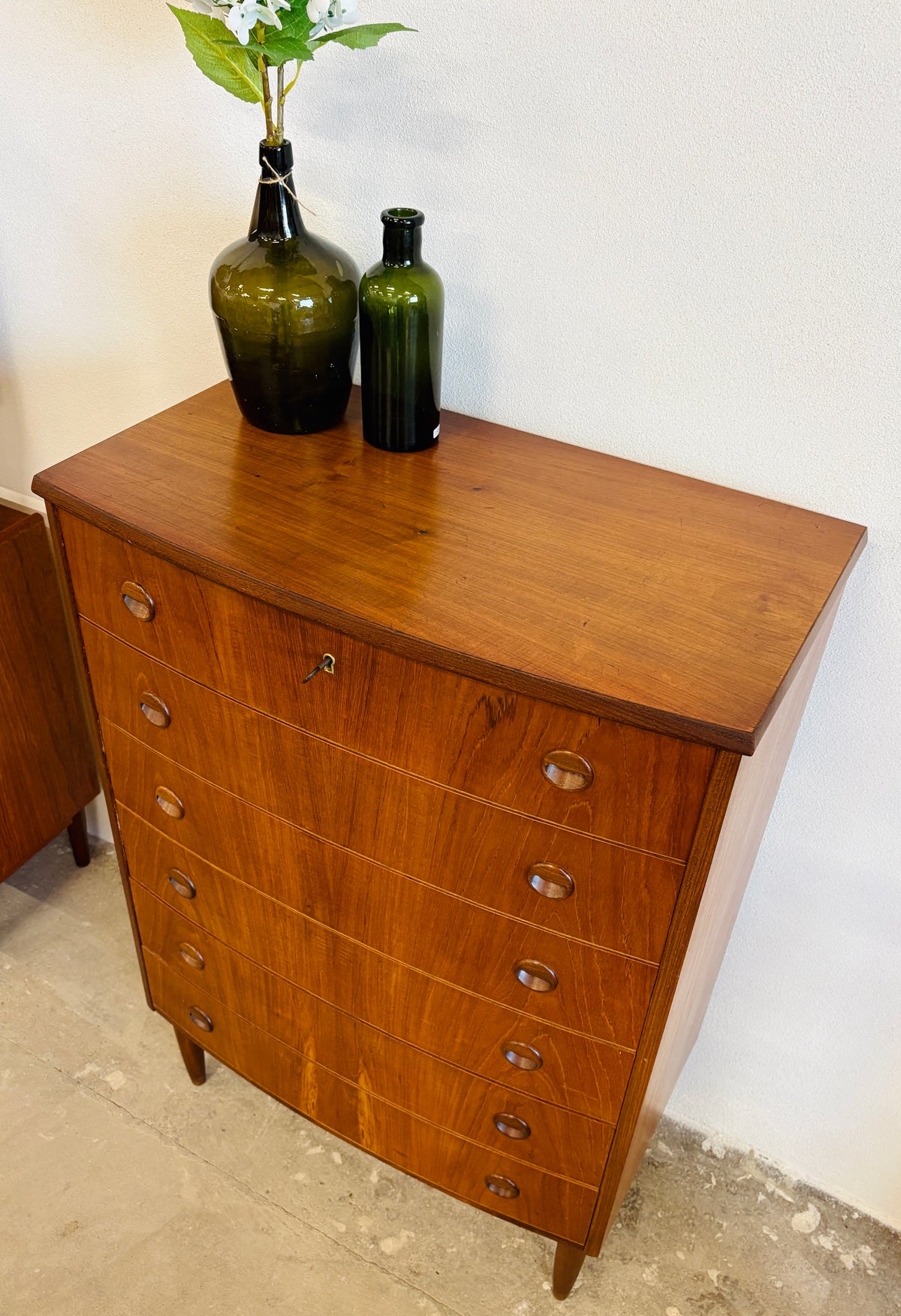 Teak chest of drawers with curved front