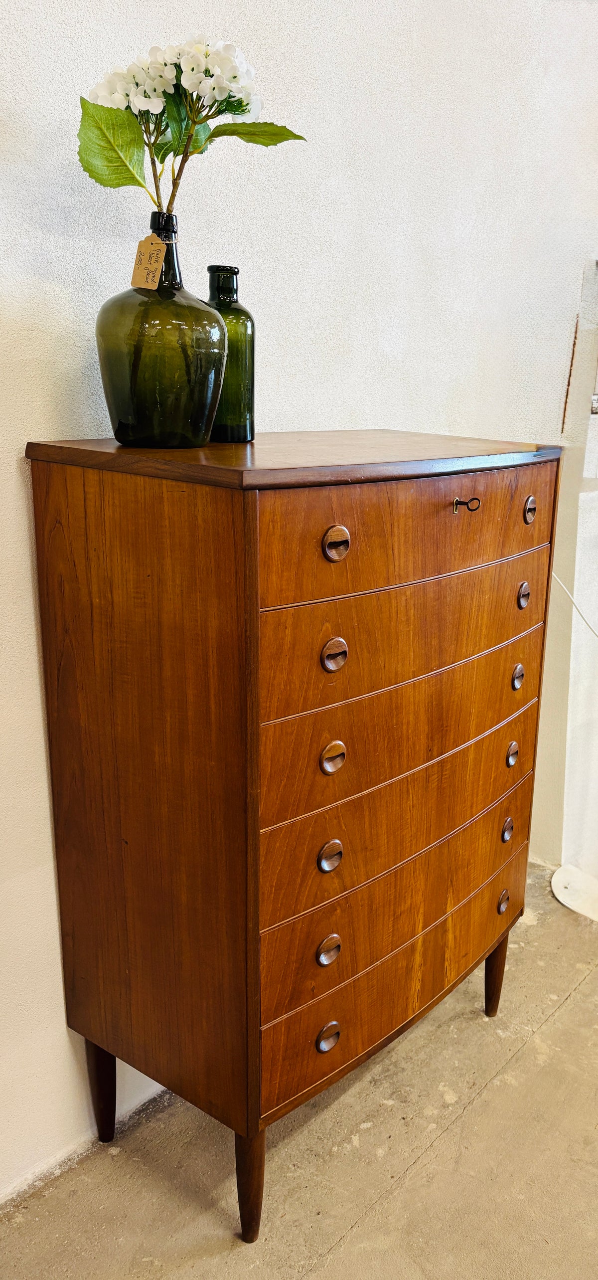Teak chest of drawers with curved front