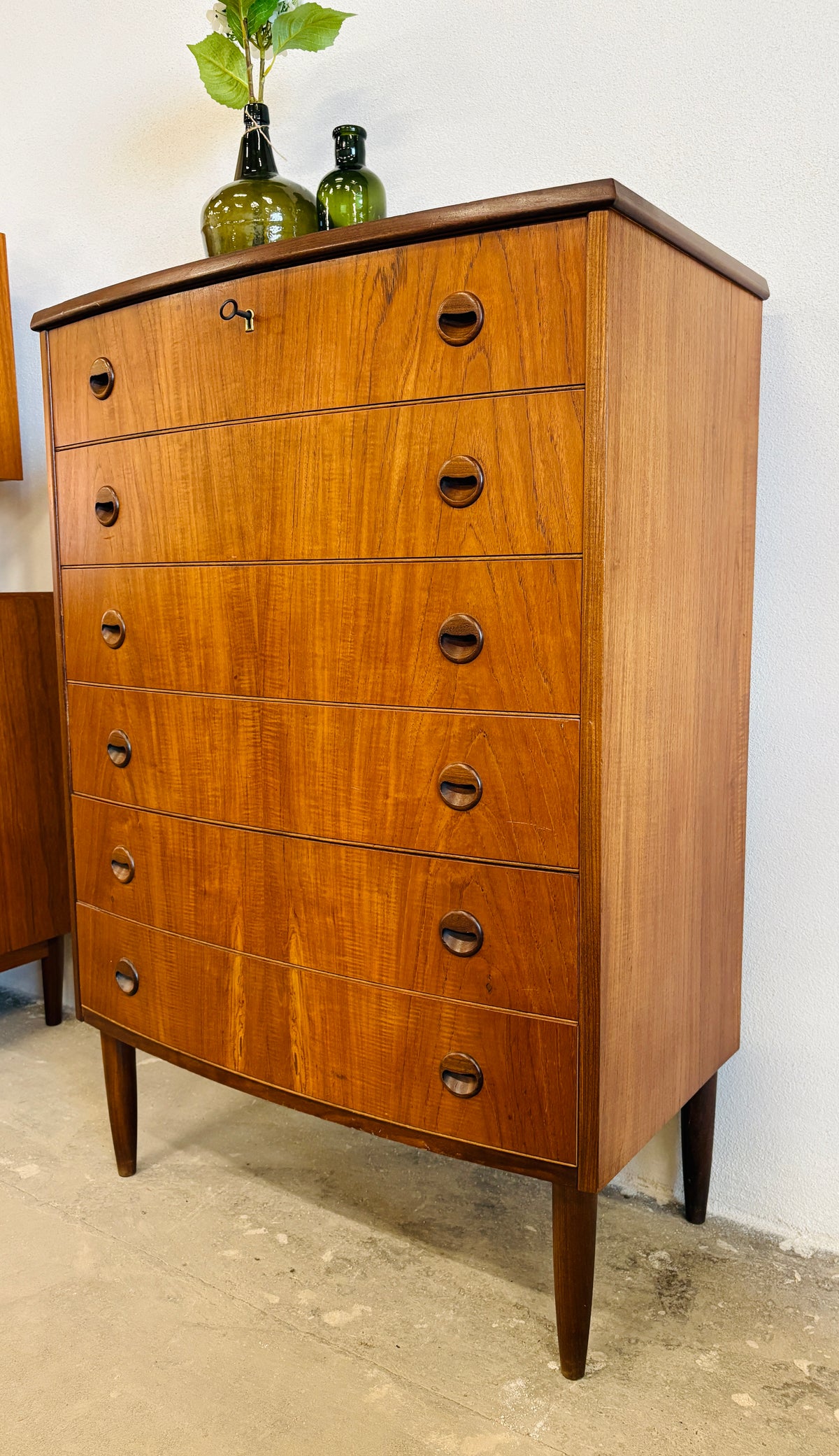 Teak chest of drawers with curved front